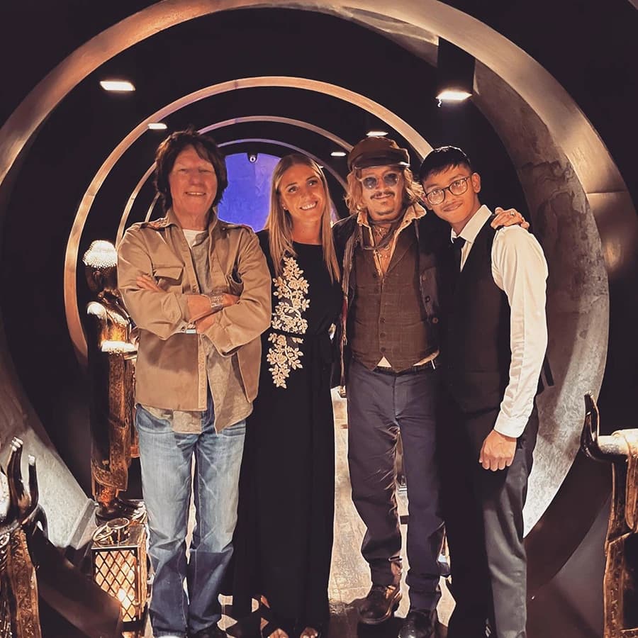 Four guests photographed together in the restaurant’s arched entrance